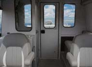 Optional enclosed head with stainless sink, 6 G freshwater tank and oversized windows with sliders
