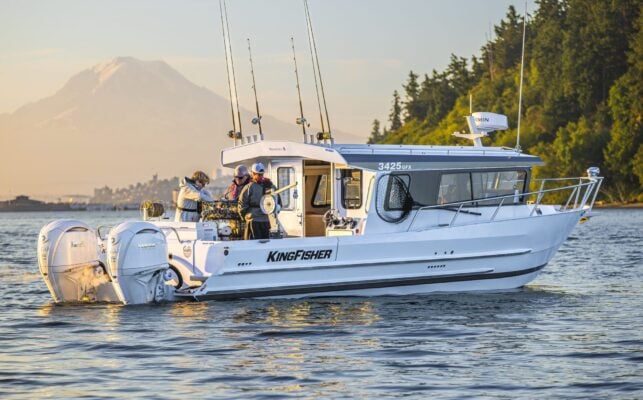 KingFisher 3425 GFX offshore aluminum fishing boat anchored in front of coastal mountain