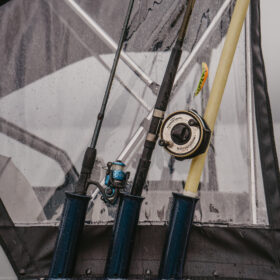 KingFisher 16 Falcon rod storage with multiple fishing rods and canvas enclosure